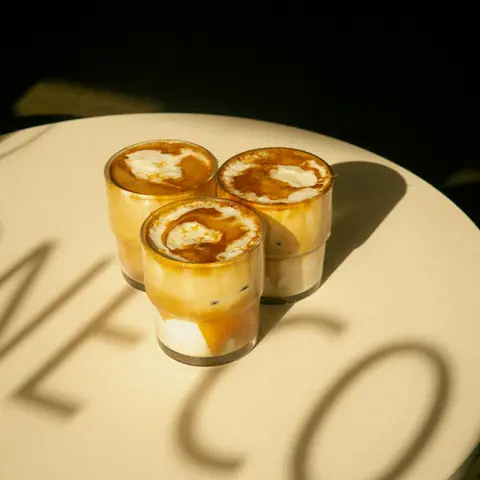 Iced Spanish latte with a caramel swirl in a glass